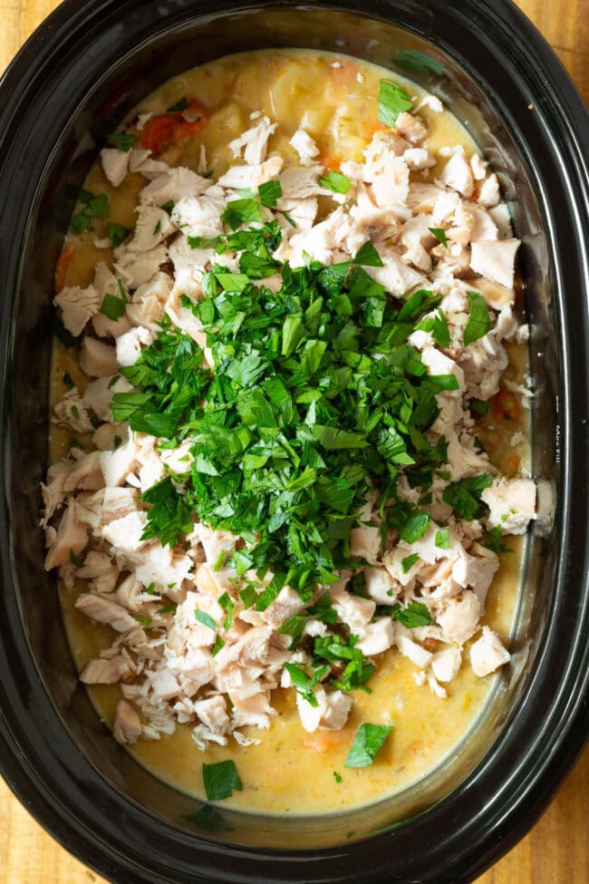 chicken potato soup in the slow cooker with chopped parsley.