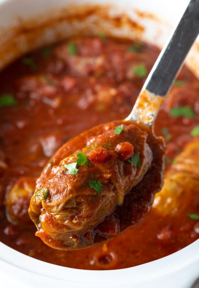 Slow Cooker Cabbage Rolls - crockpot cabbage rolls from scratch scooped up on spoon