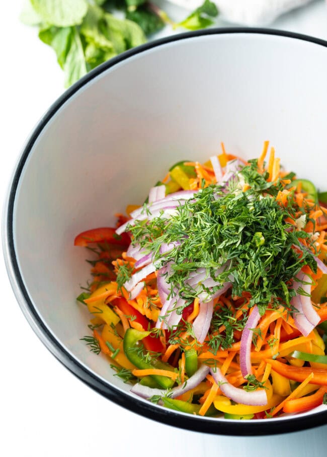 Pepper Salad - Sliced peppers, onions, and herbs in a bowl.