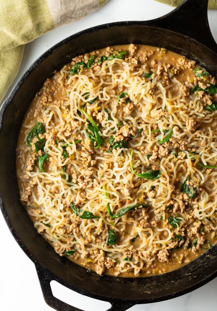 Top down dan dan low carb noodles in a cast iron skillet.