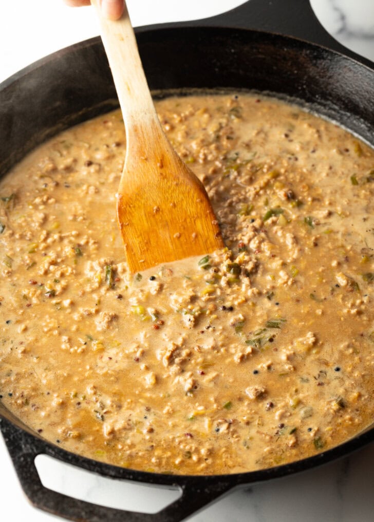 Ground pork cooked with noodle sauce in a cast iron.