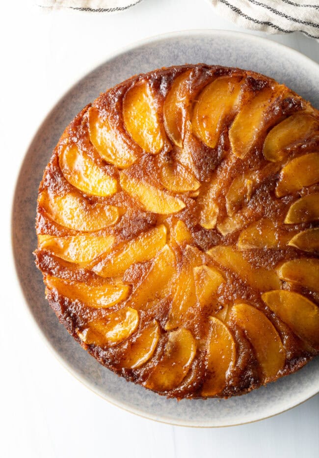 Top down apple upside down cake on a platter.