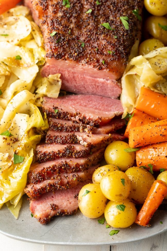 Close up of oven baked corned beef and cabbage on a platter.