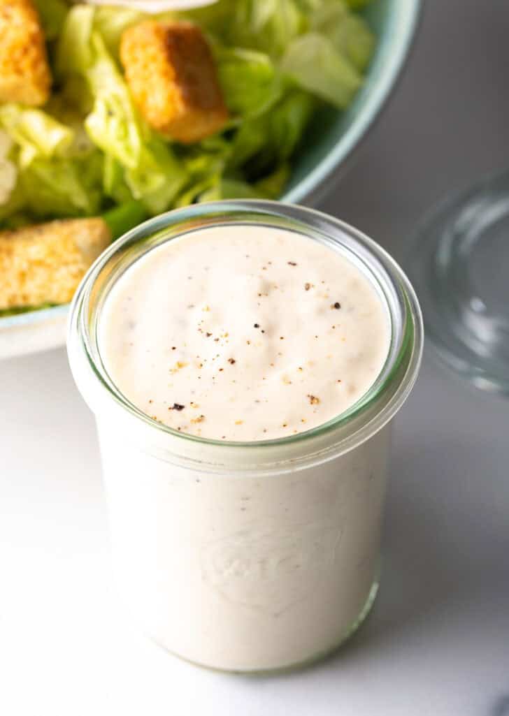 Glass jar with creamy white dressing.