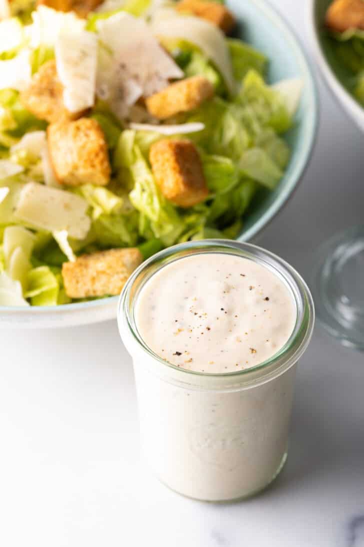 Glass jar with creamy white dressing.