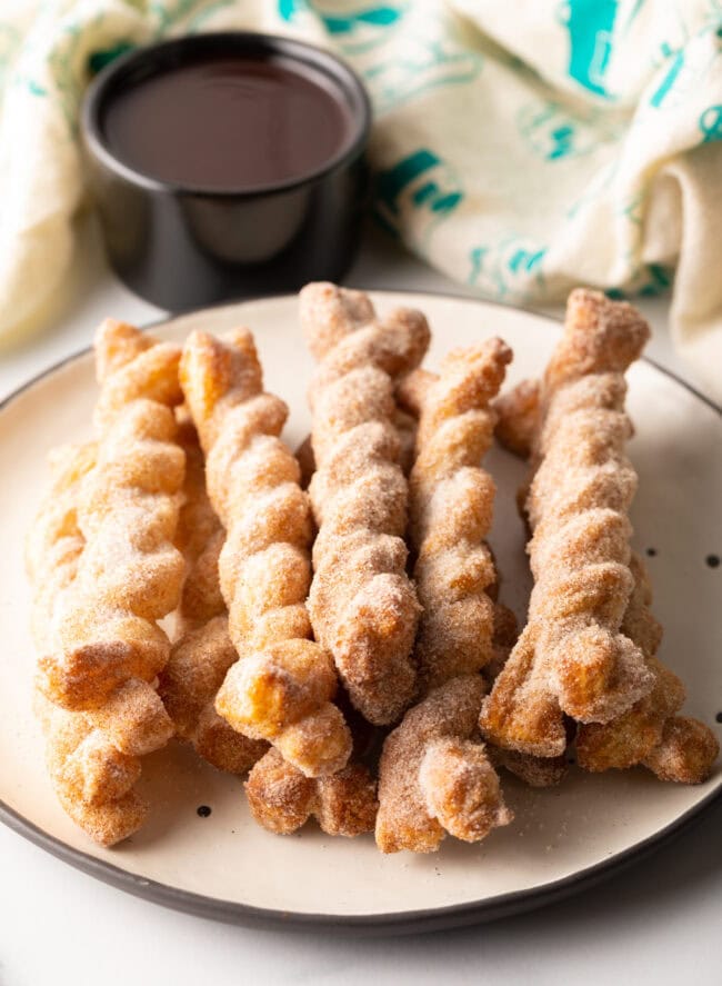 Plate of cinnamon twists stacked on top of each other.