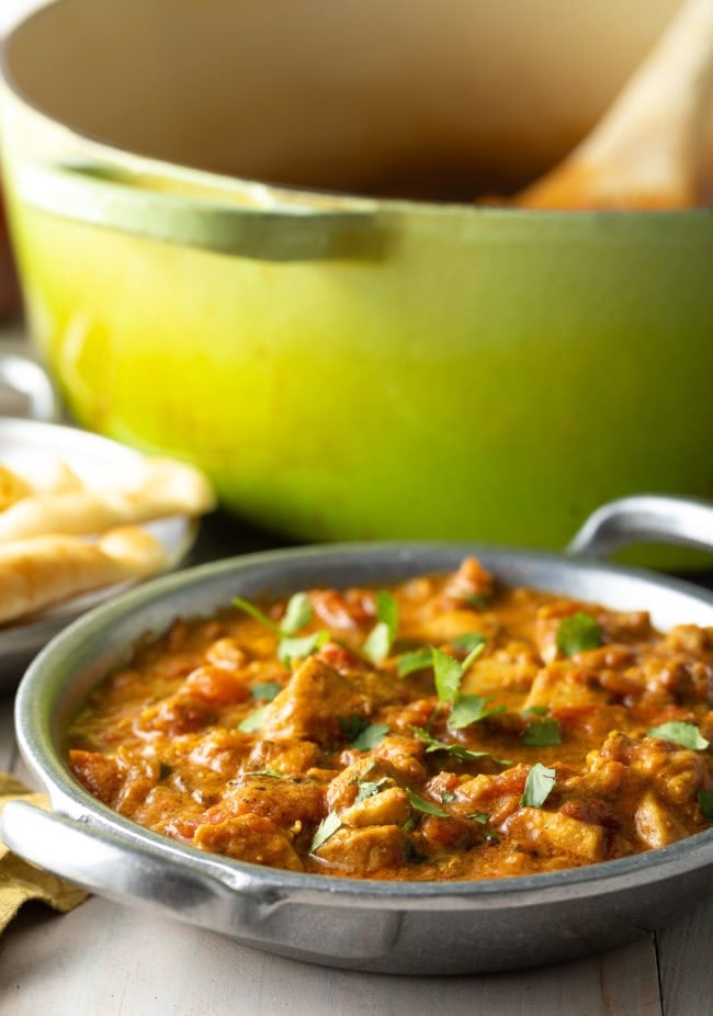 Madras Curry with chicken in a bowl with cilantro on top. 