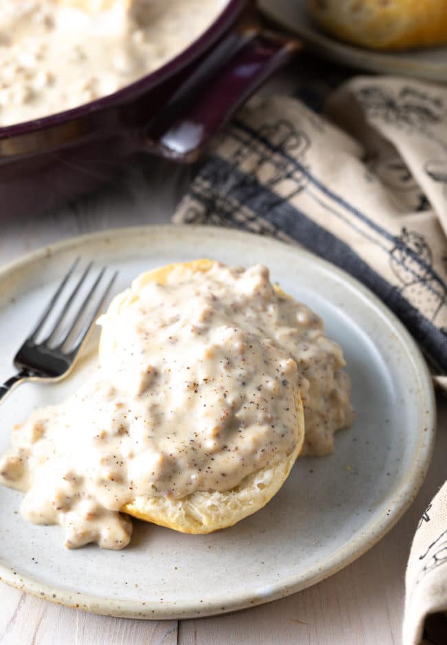 fluffy cathead biscuits covered in white sausage gravy