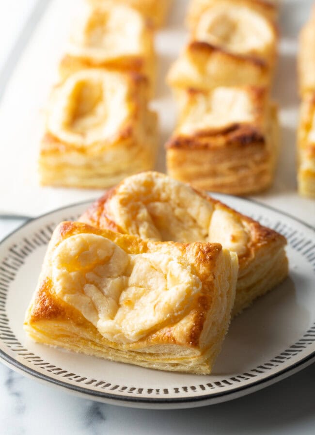 Two large Starbucks style cream cheese danishes on a white plate.