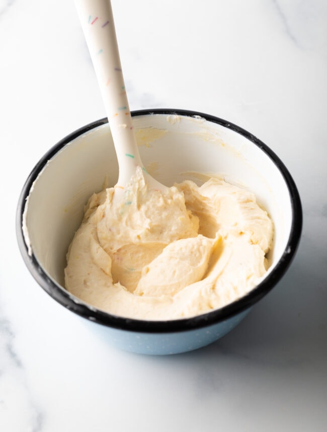 Bowl of softened cream cheese and lemon mixture for cheese danishes.