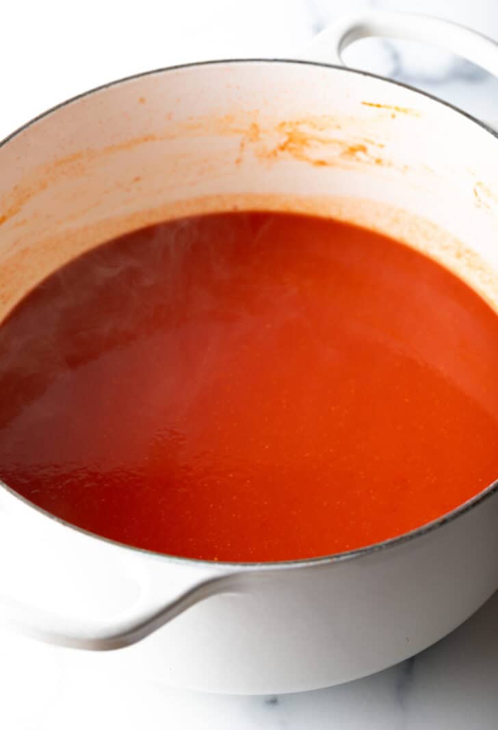 Tomato sauce in a white cooking pot.