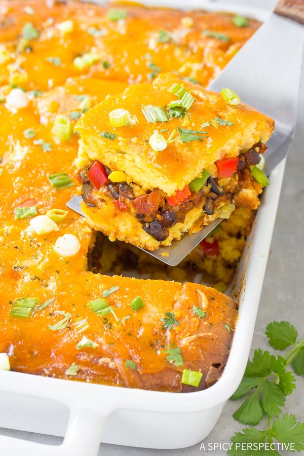 Mexican Cornbread Casserole Recipe in pan - piece lifted out