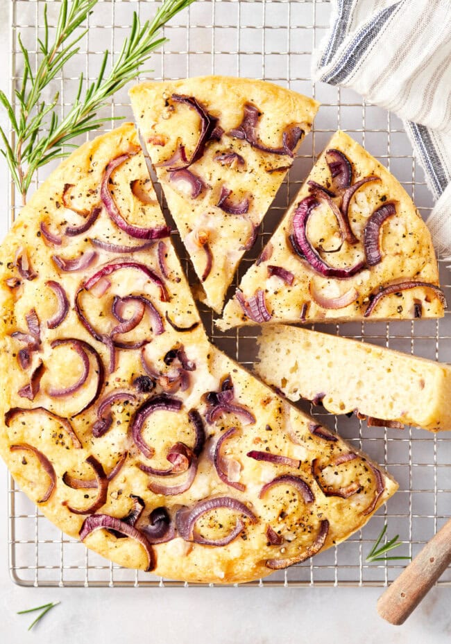 How To Make Focaccia Bread - round loaves of focaccia bread on a cooling rack. 