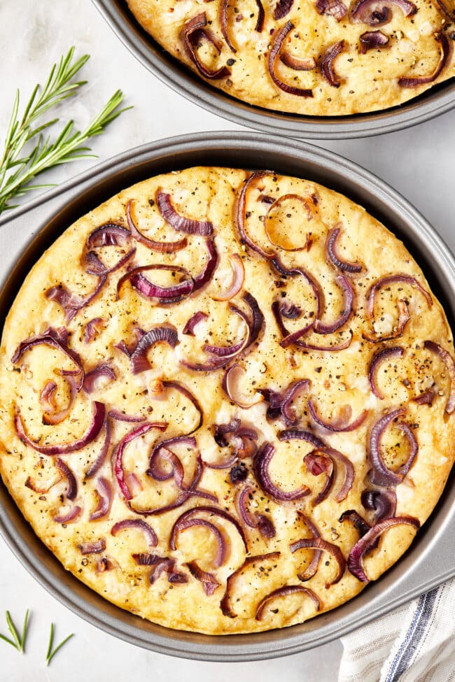 Two loaves of focaccia baked in pans 