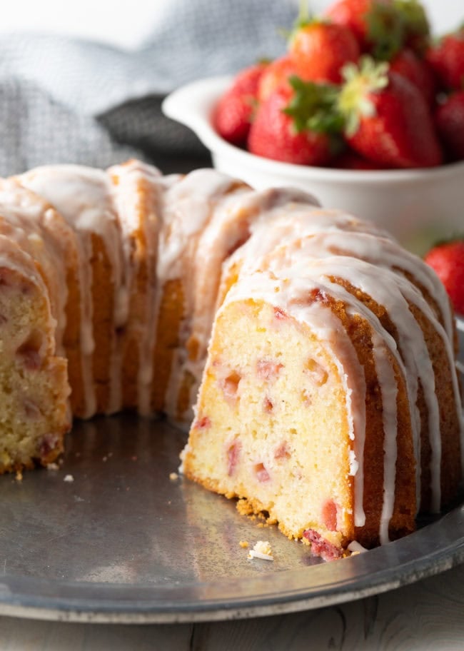 Fresh Strawberry Bundt Cake with slice missing to show the inside. 