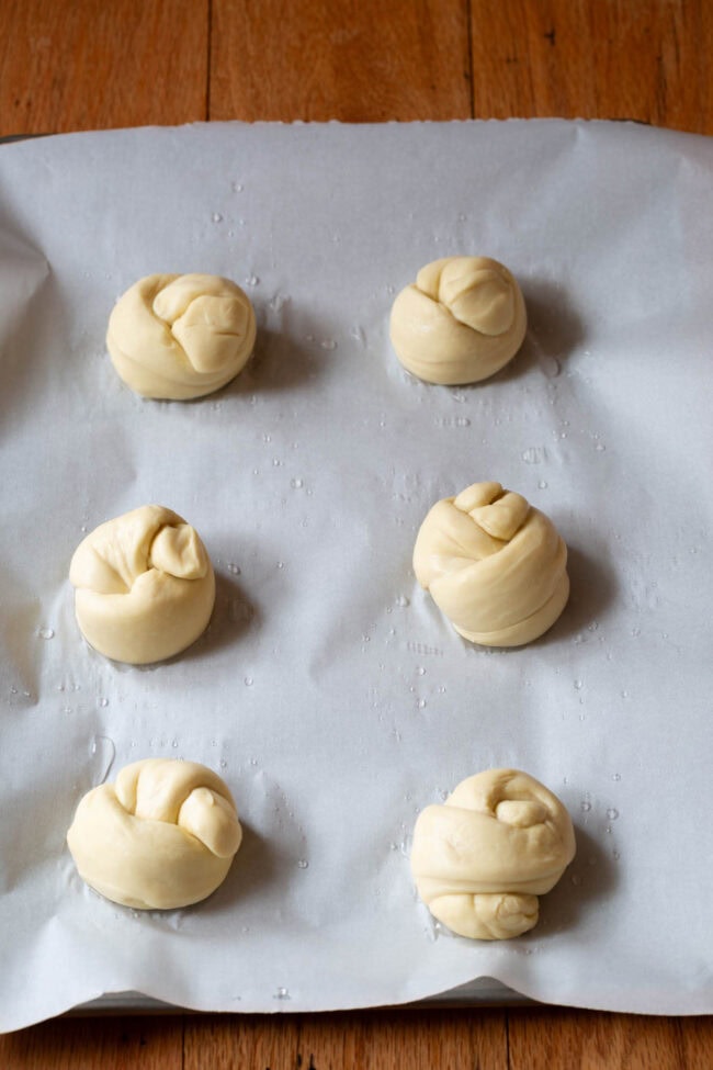 Garlic knots on a baking sheet before being baked. 