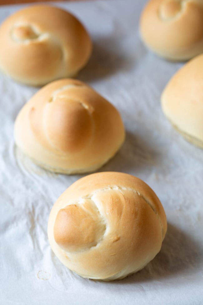 Bread knots after being baked but before being coated in garlic herb butter. 