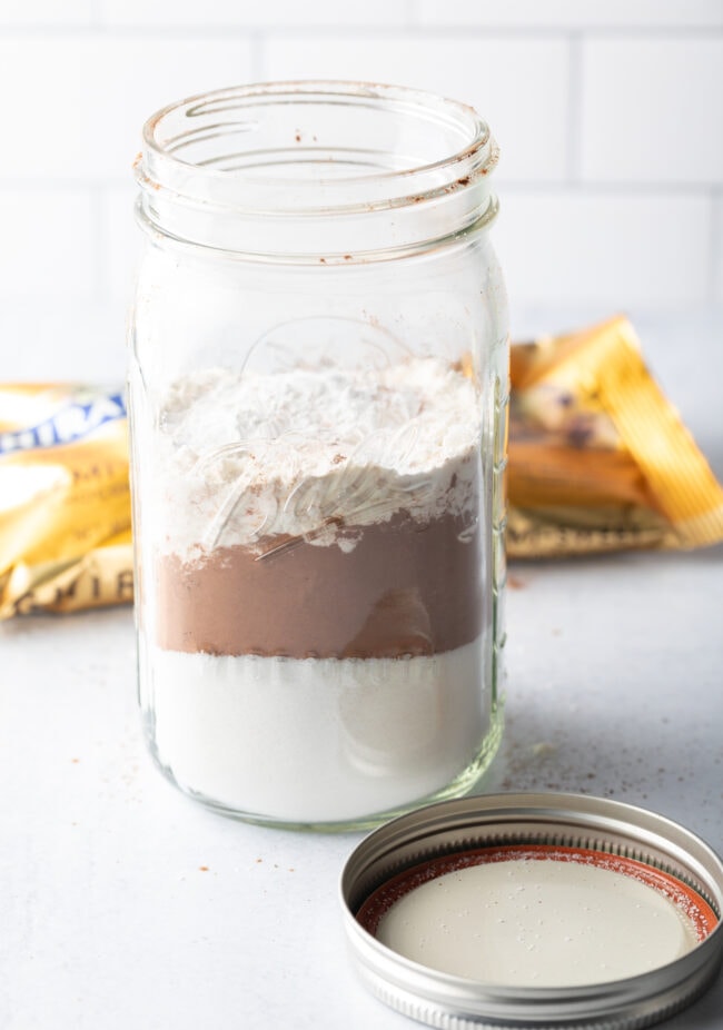 Layering dry ingredients into a mason jar.