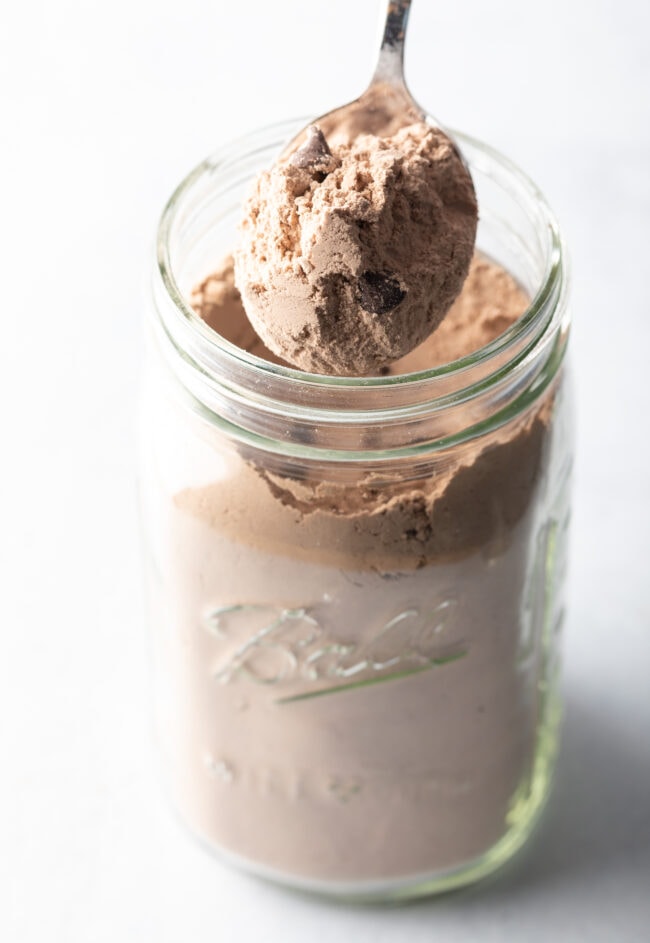 Layering dry ingredients into a mason jar.