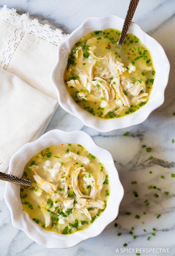 Overhead shot of two bowls of Greek lemon chicken soup. 