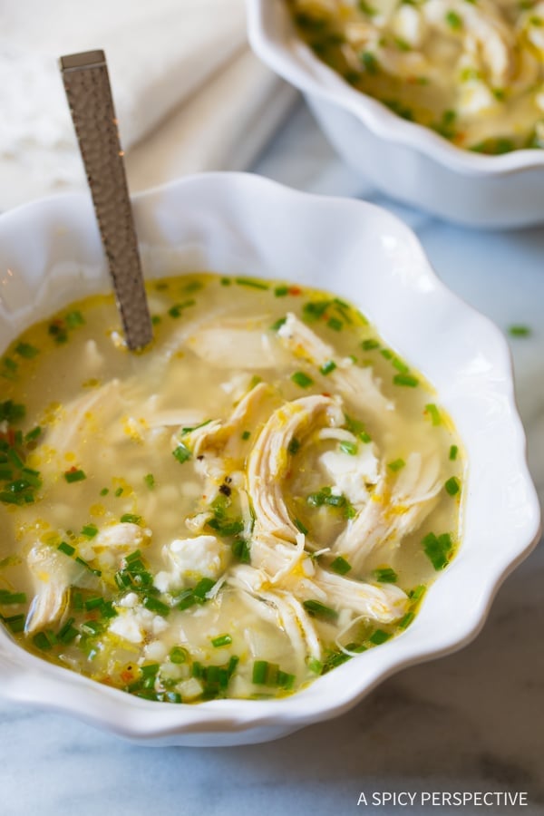 Chicken Soup in a white bowl with a spoon in it. 