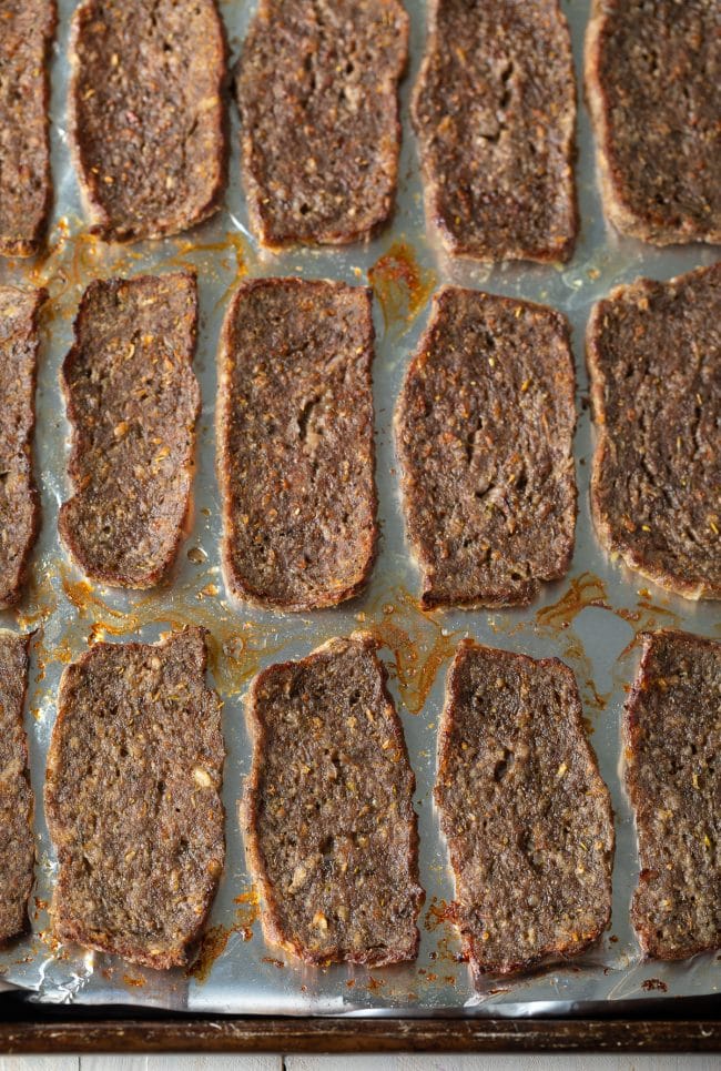 Pieces of lamb on a sheet pan after getting crispy in the oven. 