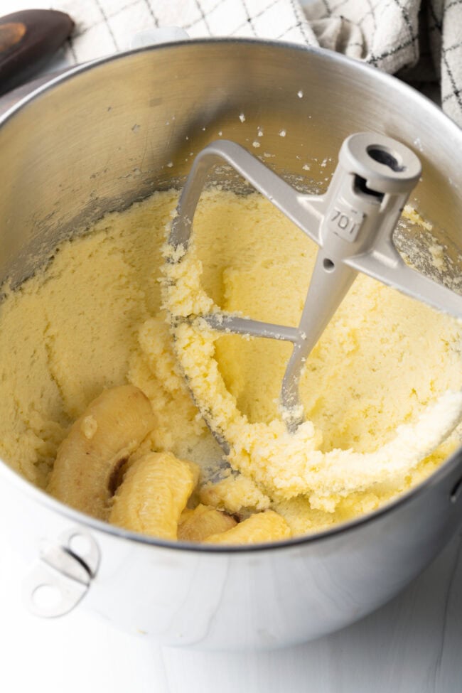 Metal bowl with batter, mixing paddle in the bowl.