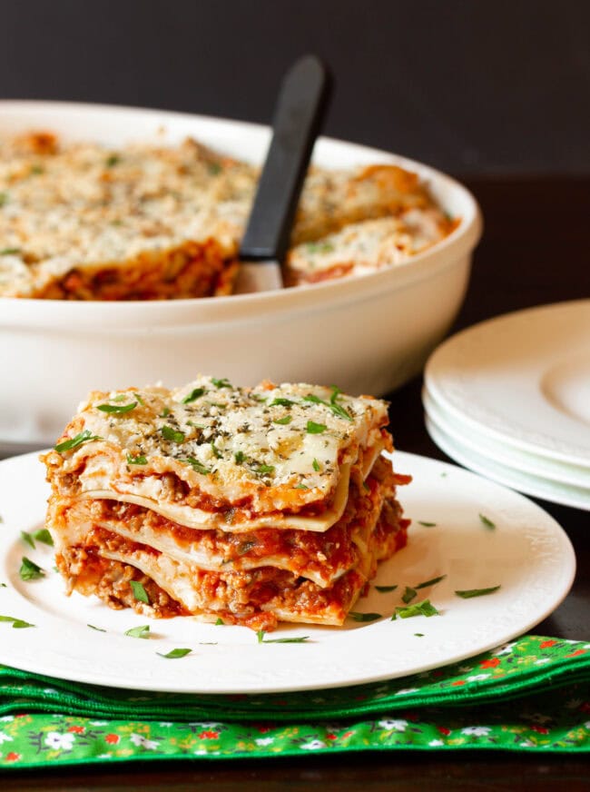 Best homemade lasagna on a plate from the side to see all the layers. 