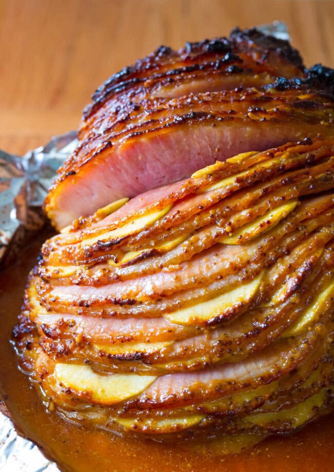 Spiral cut ham with apples sliced in between the slices with a glaze on top. 