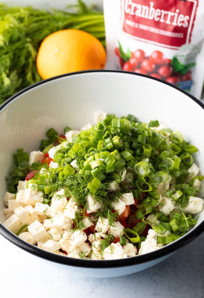 Fresh chopped green onions added to the bowl.