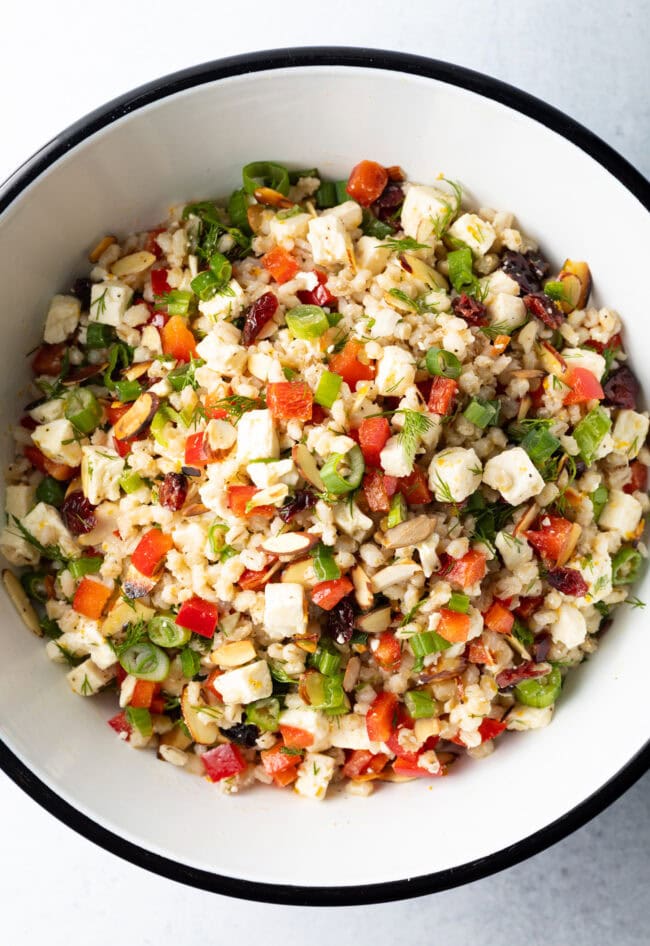 Salad with ancient grains, chopped herbs, peppers, and cheese tossed with lemon vinaigrette.