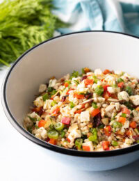 Salad with ancient grains, chopped herbs, peppers, and cheese tossed with lemon vinaigrette.