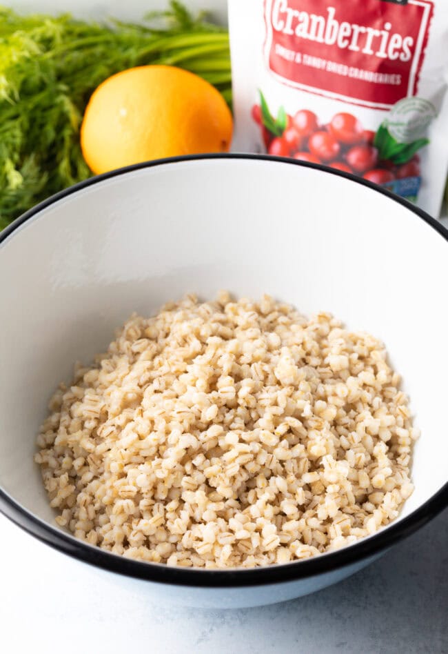 Cooked barley in a white mixing bowl.