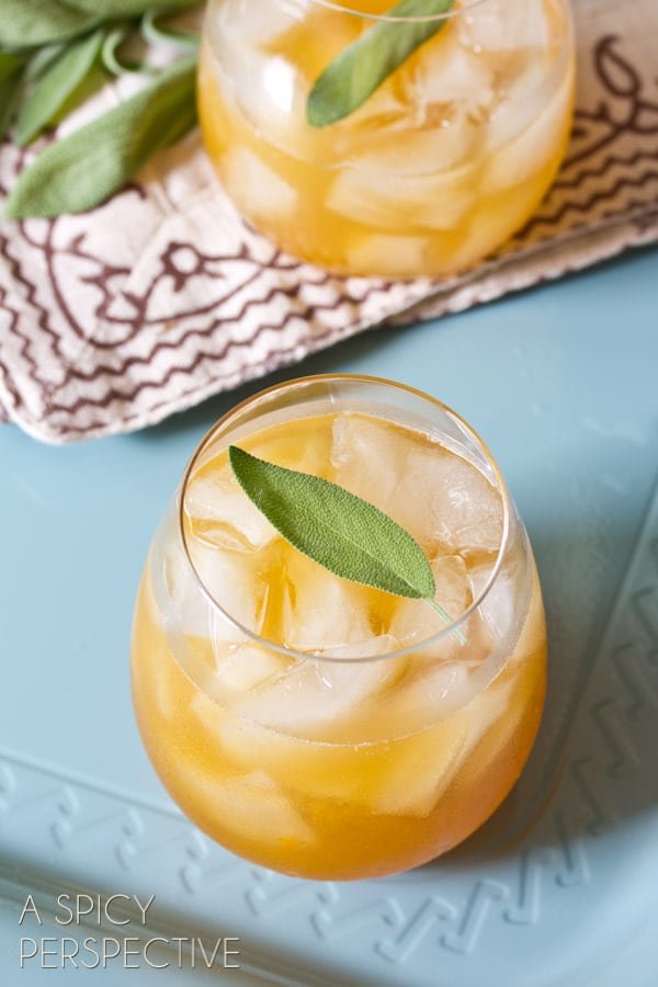 Summer Bourbon Cocktails - apricot lemon drink on tray with sage leaf