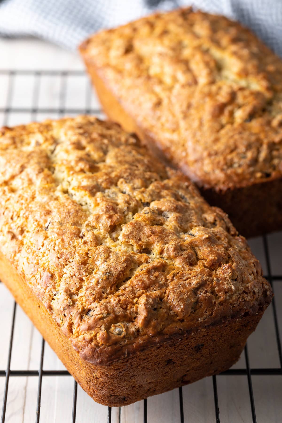 Two loaves of irish soda bread on a wire cooling rack. 