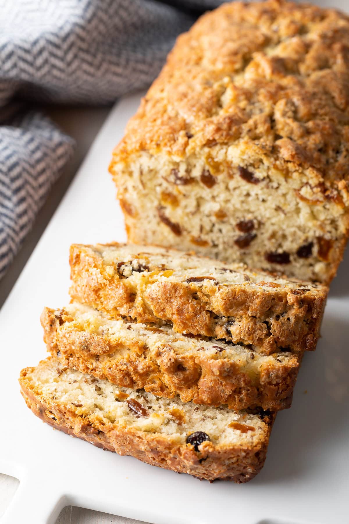 Sweet soda bread sliced for serving on a platter. 