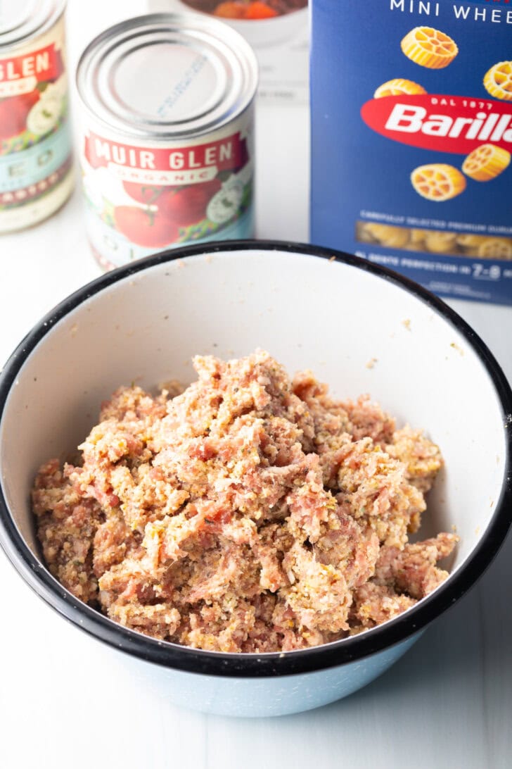 Smooth raw meatball mixture in a white bowl.