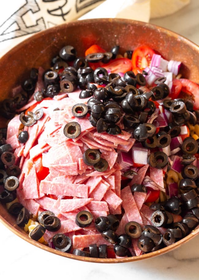 Italian Salad with salami and olives in a bowl. 