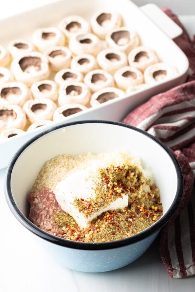 Bowl with Italian sausage filling ingredients, including sausage, cream cheese, and spices.