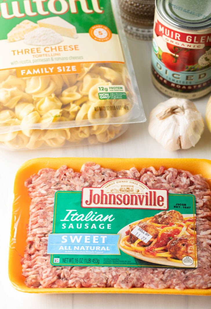 Ingredients you need: Package of sweet Italian sausage, cheese tortellini, can of diced tomatoes, and whole head of garlic.