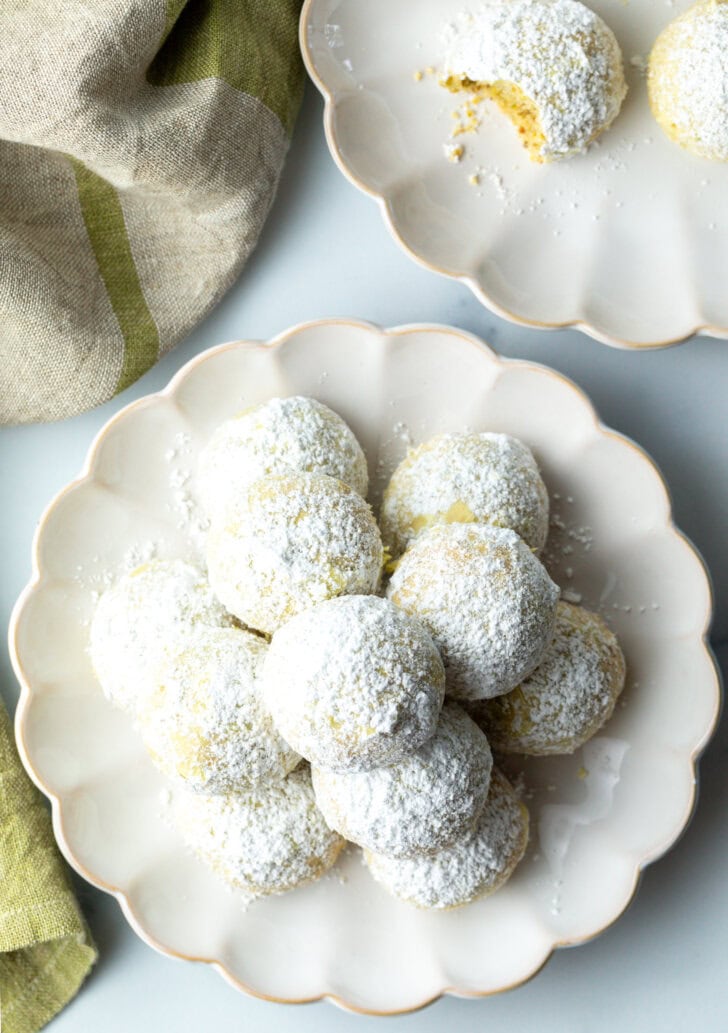 Top down view pyramid stacks of almond and pistachio Italian wedding cookies dusted with powdered sugar. (Mexican Wedding Cookies or Russian Tea Cakes)