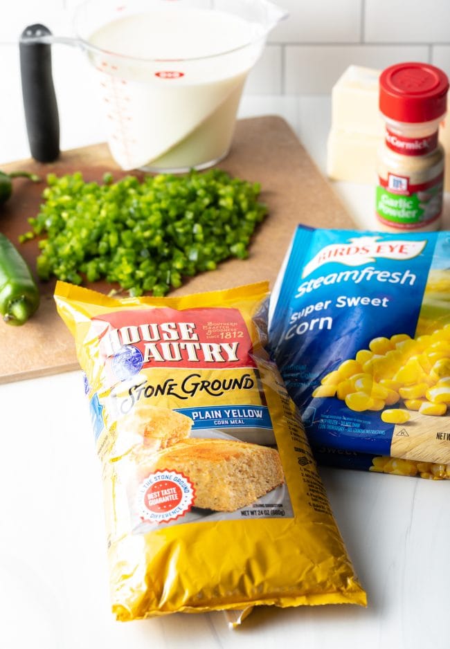 recipe ingredients including corn, chopped peppers on a cutting board