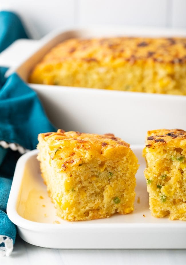 side view of jalapeno cornbread squares filled with chopped peppers and topped with cheese