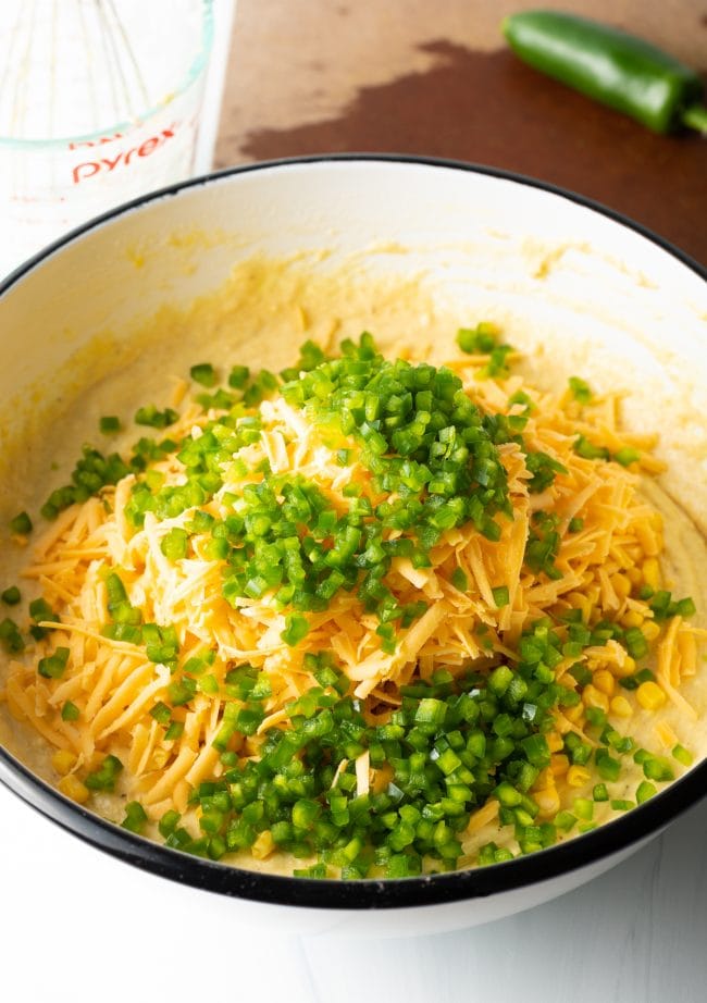 bowl with baking mix, corn meal, cheddar cheese, diced jalapenos