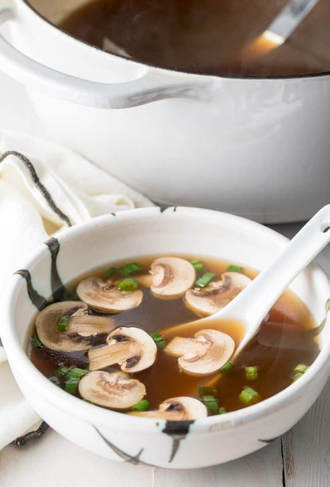 Japanese clear soup in a bowl with a large soup spoon. 