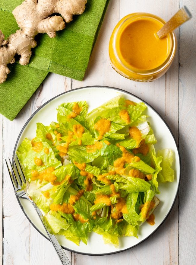 Japanese Ginger Dressing - Overhead shot of romaine lettuce with drizzle of ginger salad dressing on top. 