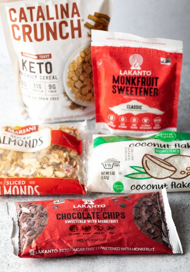 Recipe ingredients in packages: Chocolate chips, coconut, almonds, monk fruit sweetener.