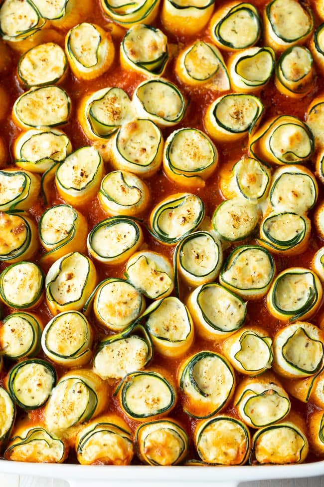 Overhead shot of keto lasagna roll ups in a marinara sauce. 