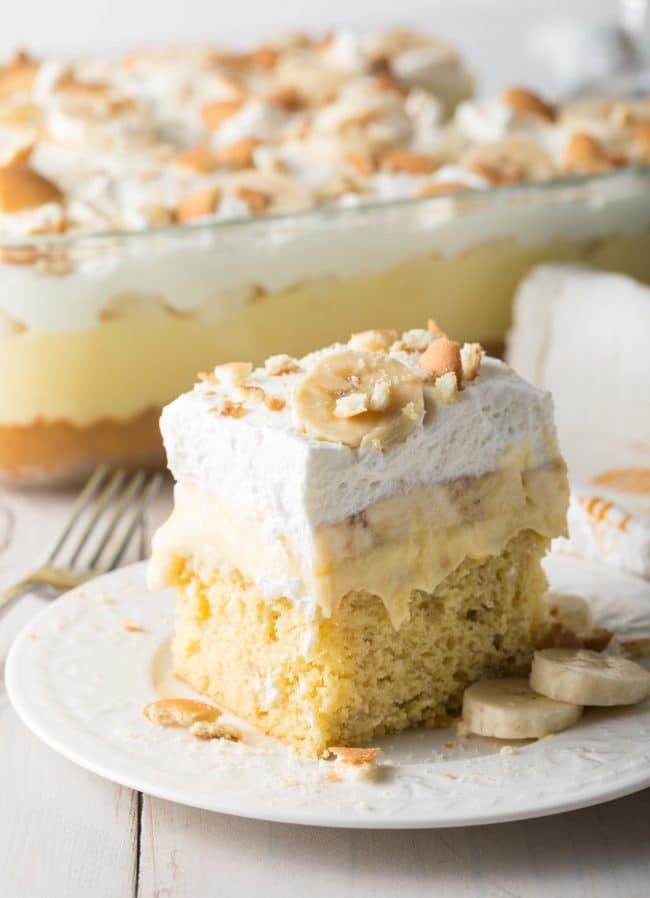 Square slice of banana pudding cake on a white plate. 