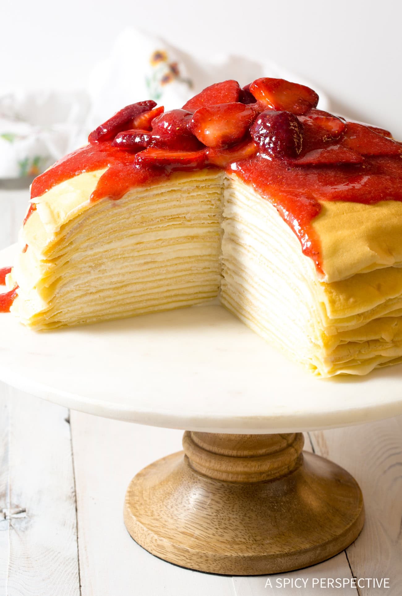 complete lemon ricotta crepe cake on a cake stand